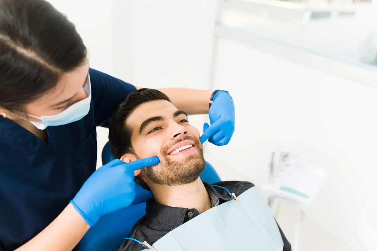 A smiling dental implant patient in the treatment chair at Premier Dental Implant Centers